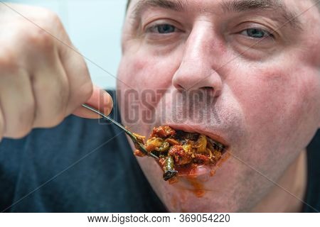 A Hungry And Fat Fat Man Eagerly Eats Roasted Meat With Spices, Fat From His Mouth Flows Through His