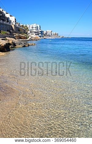 View Along The Beach And Shoreline With Buildings To The Rear, San Pawl, Malta, Europe.