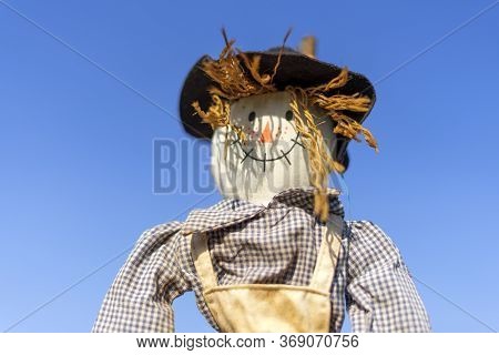 Smiling Bogeyman In A Garden Or Field Against A Blue Sky. Bright Sunny Summer Day. Shallow Depth Of 
