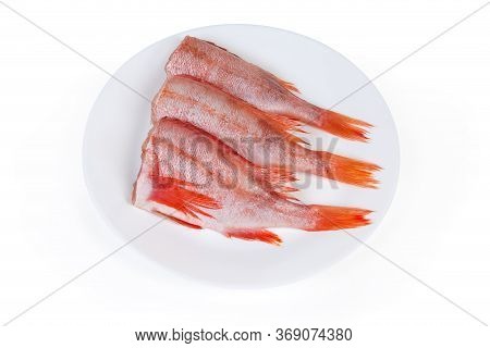 Uncooked Headless Gutted Carcasses Of Redfish Also Known As Ocean Perch Or Norway Haddock On The Whi
