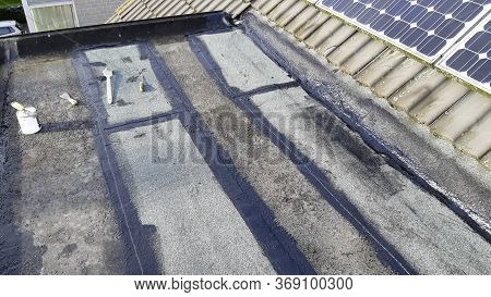 Tar Foil Roof Repair: New Patches Installed To Prevent Further Leaking From The Roof. Emergency Repa