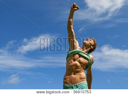 Happy Fit Man With His Arm Raised In Joy