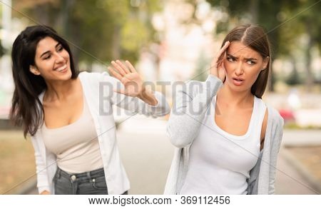 Girl Avoiding Meeting Toxic Friend Girl Ignoring Her Greeting Walking In Park Outdoors. Selective Fo