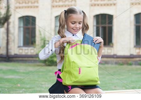 Library For Enjoyment And For Schoolwork. Happy Child Pick Library Book Out Of Bag. Little Girl Go T