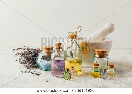 Aromatic Oils In Glass Bottles, Aromatic Salts, Marble Mortar And Dry Lavender. Concept Natural Ogra