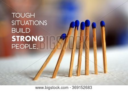 Inspirational Quote - Tough Situations Build Strong People. On Background Of  Blue Wooden Matches St