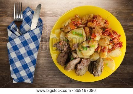 Fried Liver With Potatoes And Stewed Tomatoes With Fork And Knige. Fried Liver On Yellow Plate On Br
