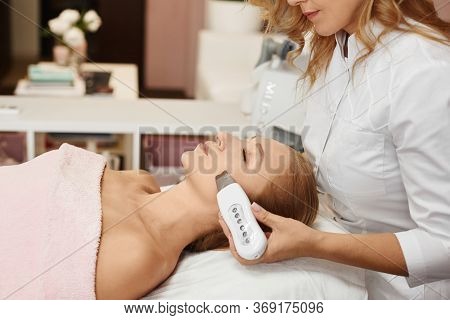Beautiful Woman Getting Face Peeling Procedure In A Beauty Clinic, Non-surgical Facelifting Procedur