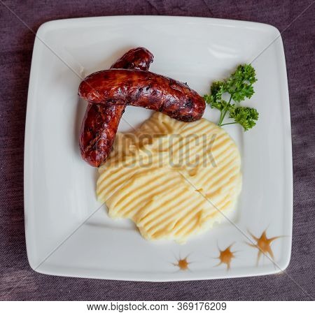 Potatoe With Sousages On The White Plate