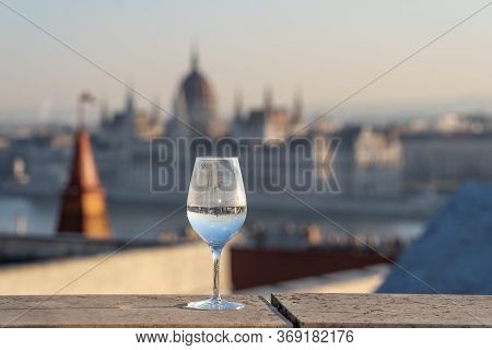 Reflection In Wine Glass Of Hungary Paliament Hazy Figure In The Background