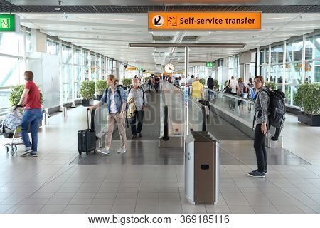 Amsterdam, Netherlands - July 7, 2017: Travelers Visit Schiphol Airport In Amsterdam. Schiphol Is Th