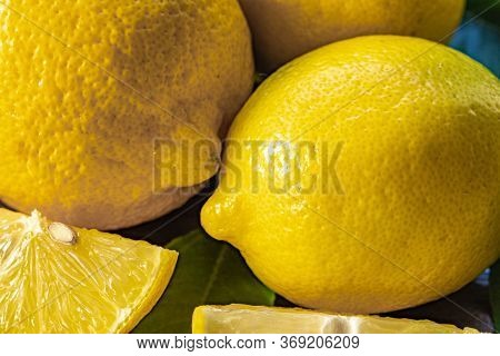 Top View Of Lemon And Green Leaves On Wooden Background