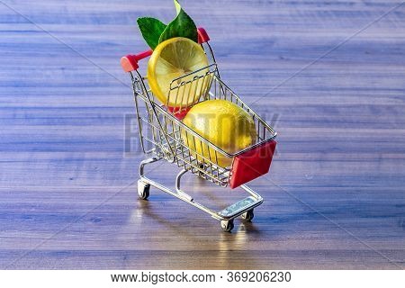 Supermarket cart carrying green leaf and lemon