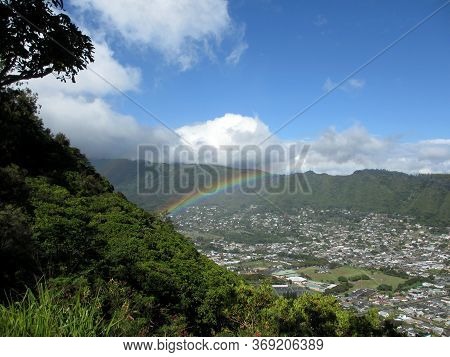 Rainbow Over Manoa Town On The Island Of Oahu Seen From Tantalus Mountain.
