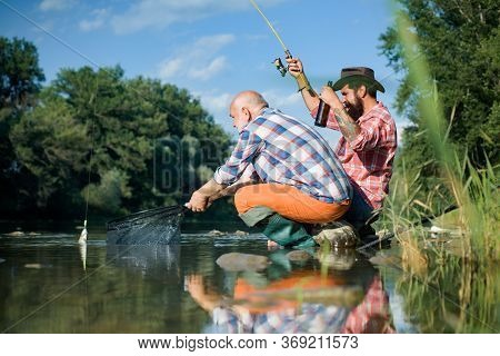 Big Game Fishing. Summer Weekend. Two Fishermen Relaxing Together With Beer While Fishing On Lake At