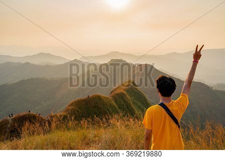 Traveler Man Hiking Enjoying In The Mountains With Backpack At Khao Chang Puak Mountain Thailand