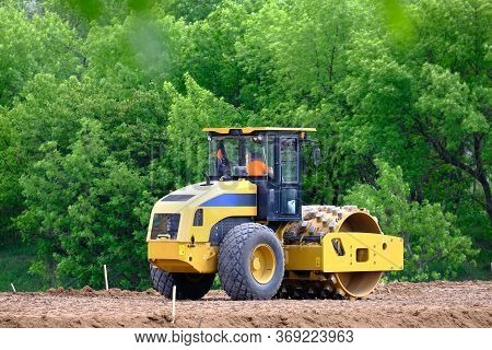 Soil Skating Rink, Road Roller Making New Highway. Heavy Industrial Machine Working On Construction 