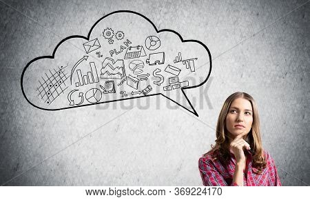 Serious Woman Looks Pensive Upwards And Thinking Something. Speech Bubble Full Of Business Diagrams 
