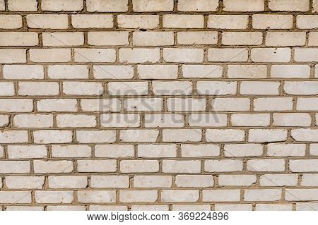 Texture Of An Old Exterior Wall Surface Made Of White Bricks. Bricks Are Aged And Weathered With Cru