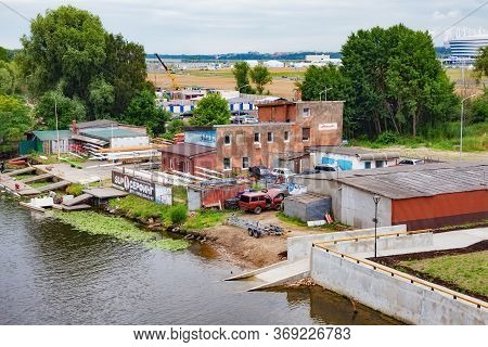 Kaliningrad, Russia - June 13, 2018: Old Industrial Buildings On The Pregolya River Coast In The Sub