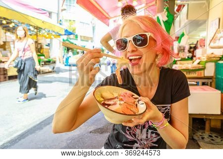 Caucasian Lifestyle Happy Tourist Woman Eats With Chopsticks, Sashimi Salad At Ameya-yokocho Market 