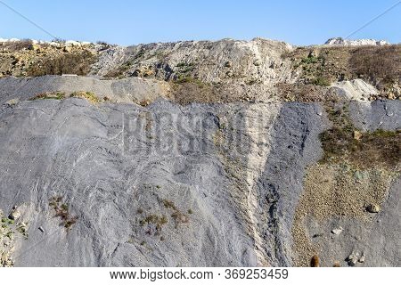 Spoil Pile Hillslope With Gravel And Stones In Sunny Ambiance