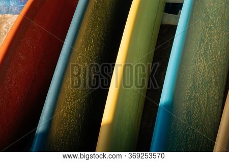 Set Of Colorful Surfboard For Rent On The Beach. Multicolored Surf Boards Different Sizes And Colors