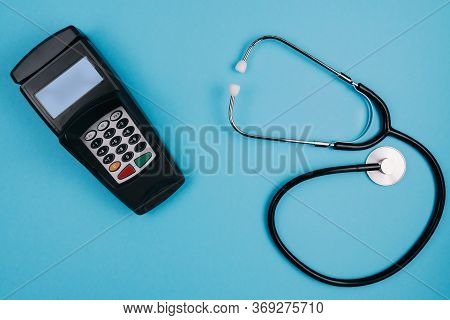 Cost And Payment For Medical Treatment Or Copay Concept, Above Shot Of Stethoscope And Credit Card R