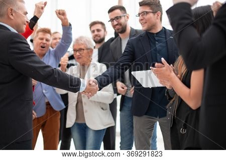 Businessteam is introducing a colleague to another businessman