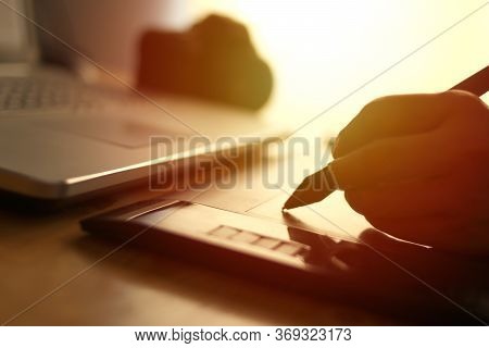 Anonymous Designer Working On Laptop Computer And Pentablet Graphic Tablet, Blurry Silhouette With S