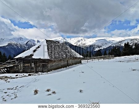 Wooden Shelter / Sheepfold In The Mountains During Winter. Winter Landscape In The Mountains .