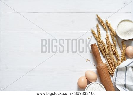 Baking Background With Flour, Wheat Ears And Rolling Pinon Concrete Background. Top View With Copy S