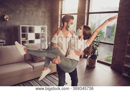 Photo Of Young Couple Guy Hold Arms Excited Lady Quarantine Together Stay Home Hugging Happy Have Fu
