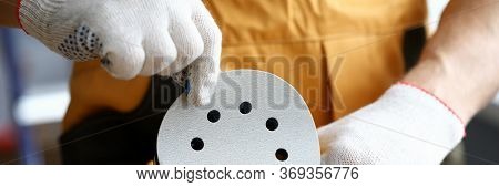 Close-up Of Male Worker Changing Disc On Sander Machine. Cropped Picture Of New Professional Instrum