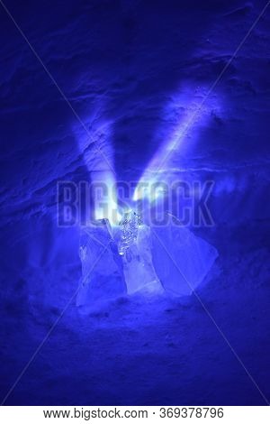 A Small Light Source Causes Exploding Purple Rays To Spread Out From Behind These Chunks Of Ice. Ref