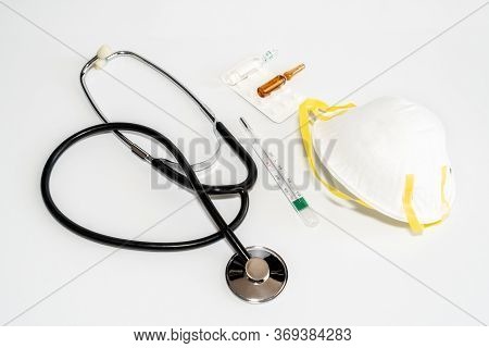 Medical Masks With Elastic Band, Thermometer, Medicine And Stethoscope, Isolated On White Background