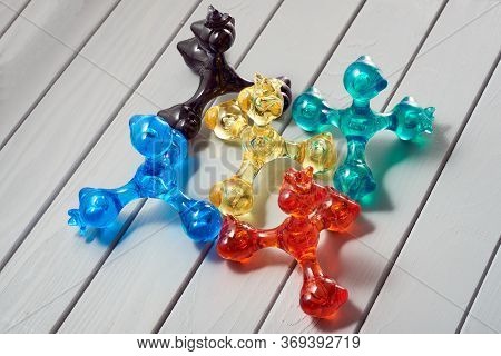 Five Hand Masseurs Called Pharaoh, Of Different Colors, Stand Together On A Village Background. For 