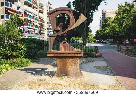 Riesa/germany - July 23/2018: Photo Of Cityscape With Houses, Asphalt Road, 
Old Rusty Monument In T