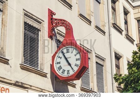 Riesa/germany - July 23/2018: Photo Of Big Red Vintage Clock On The Wall Of A House