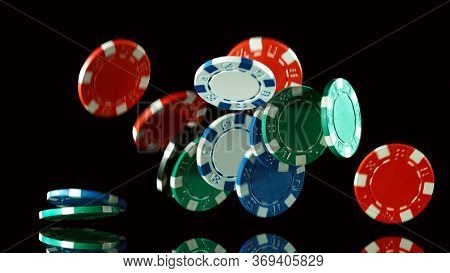 Poker still life with falling poker chips . Concept of hazard gaming. Isolated on black background