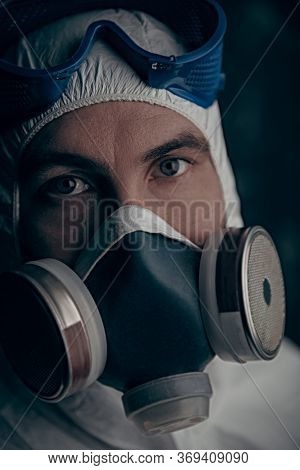 COVID-19 or 2019-nCoV. Close-up portrait of a scientist microbiologist in respiratory mask. Pandemic.