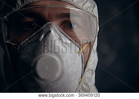 COVID-19 or 2019-nCoV. Close-up portrait of a scientist microbiologist in respiratory mask. Pandemic.