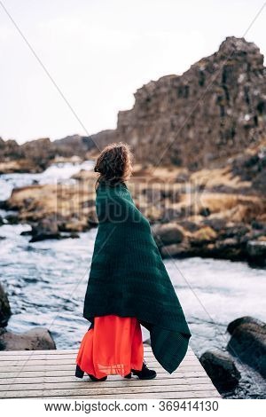 A Girl In A Red Dress Near Ehsaraurfoss Falls, Ehsarau River, National Park, Tingwedlir, Sudurland R