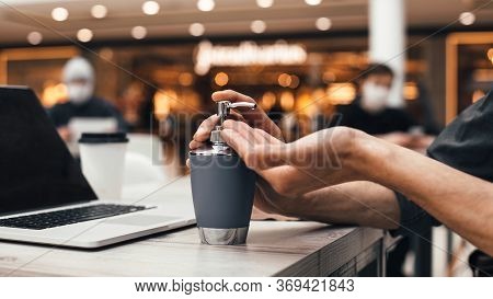 Close Up. Man Applying A Decontaminating Gel To His Hands.