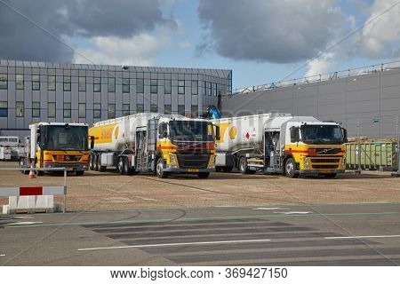 ROTTERDAM AIRPORT, THE NETHERLANDS - CIRCA 2019: BIg fuel trucks parked at an airport, Shell branding. Flying burns large amounts of fossil fuel, significant greenhouse gas emission.