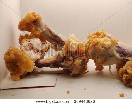 Waste Chicken Bone On A White Background Close-up, Bones In A Food Box.