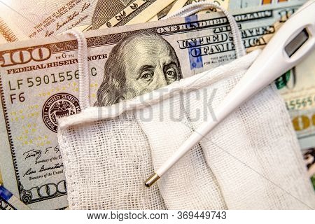 A Hundred-dollar Bill With A Medical Mask .the Concept Of Coronavrius Epidemic