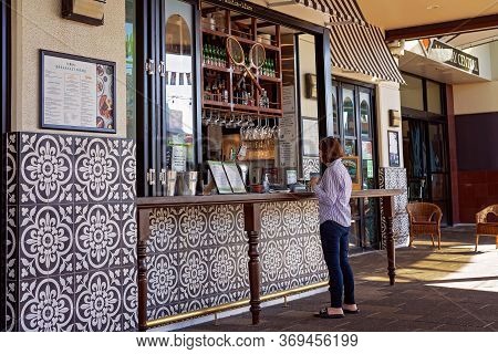 Mackay, Queensland, Australia - June 2020: Woman Ordering At The Counter Of An Open Air Sidewalk Cof
