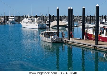 Mackay, Queensland, Australia - June 2020: Three Fishermen Looking At Boat Moored In A Marina Berth 