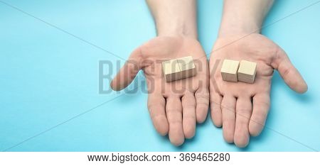 Wooden Cubes In Men's Hands On A Blue Background